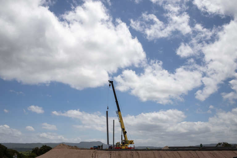 A crane installs a structure for the packing plant at the Orchid ZEDE. San Marcos de Colon, July 23,  2021. Photo by Martín Calix