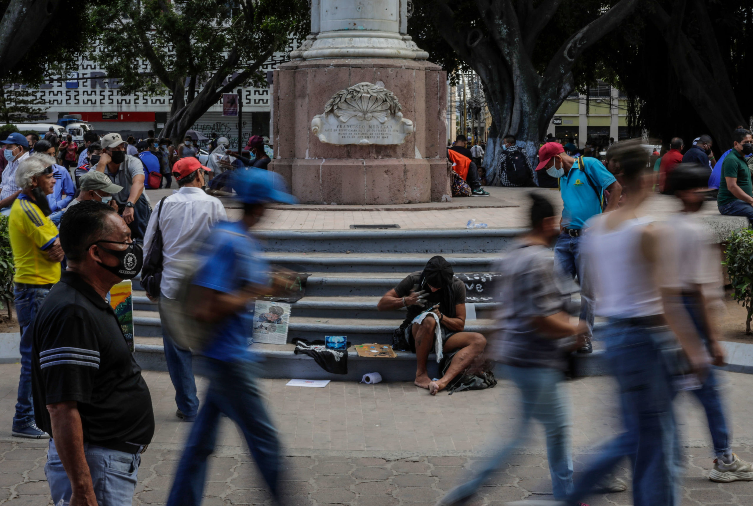 El tiempo pasa rápido durante su proceso creativo en el centro de Tegucigalpa y se rodea de seguidores con quienes bromea. Foto CC/Jorge Cabrera